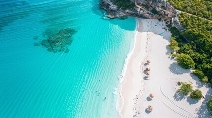 Aerial view of a coastal beach with turquoise waters and white sand with