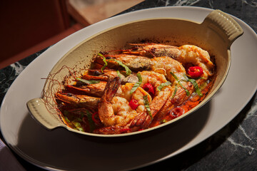 Oven baked jumbo shrimps. Large shrimps cooked with tomatoes and sauce. Close-up, stylish food