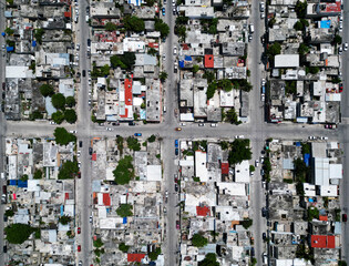 Aerial top-down view high altitude of slum a heavily populated urban informal settlement characterized by substandard housing and squalor poor living conditions streets and rusty metal home roof tops