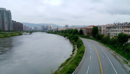 Winding Road Along a Riverbank with City Buildings