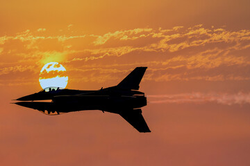 Two military jets fly through burnt cloudy skies with the sun in the background