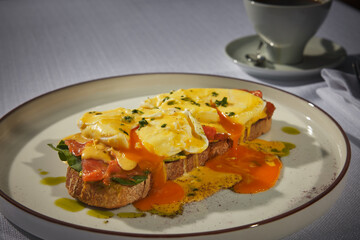 Fine dinning food. A stylish looking plate prepared with toast, arugula, egg and tomato sauce.