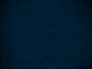 Dark blue grunge texture background, characterized by a rugged and uneven surface in various shades of blue.