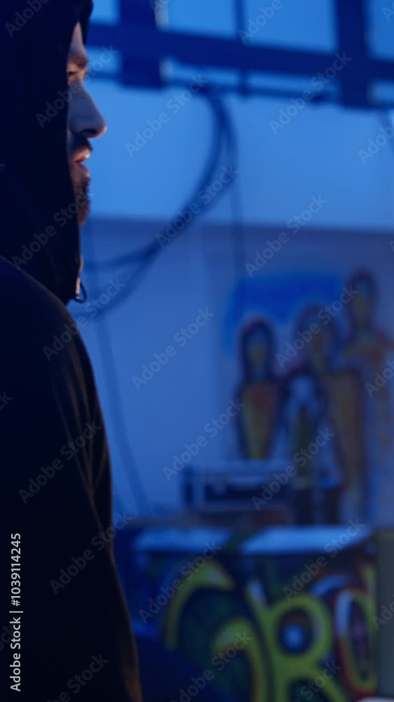 Poster vertical video hacker arriving in underground base, ready to do computer sabotage using encryption t
