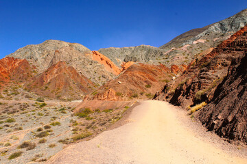 A serene view of the Seven Colors Hill framed by the clear blue sky, Purmamarca, Jujuy, Argentina.