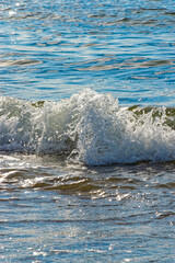sea ​​wave water like crystal in the sun, the movement of a sea wave frozen in stillness - taken with a Nikon SLR camera, 24 Mpix matrix