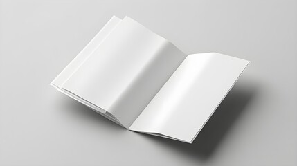 Top view blank white brochures, open and closed layout on neutral grey backdrop, minimalistic presentation for design mockups