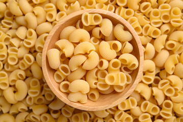 Raw macaroni pasta in bowl with macaroni pasta background, Food ingredient, Top view
