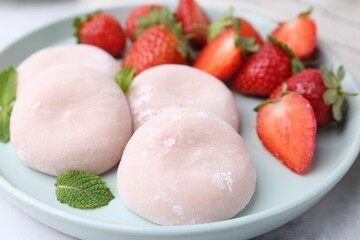 Delicious mochi, strawberries and mint on table, closeup