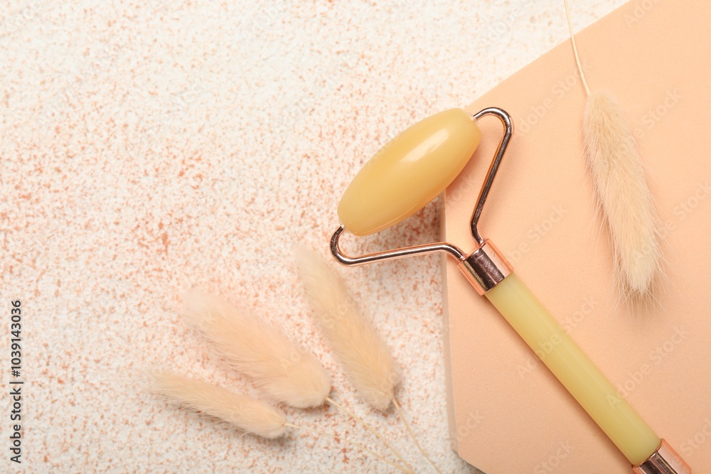 Poster Face roller and dry spikes on beige textured background, flat lay. Space for text