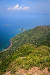 A Panoramic View of Rugged Coastline and Lush Green Hills