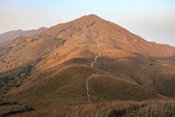 Winding Path Leading Up a Rocky Mountain at Sunset