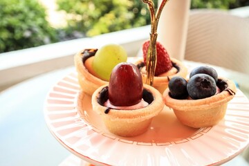 Delicious Mini Fruit Tarts on a Display Stand