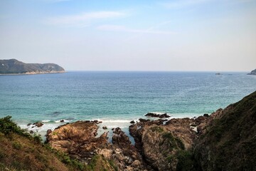 Rocky Shoreline with Turquoise Ocean Waves Crashing