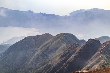 Fototapeta premium Scenic Mountain Ridge with Misty Background View, Lantau Peak, Hong Kong