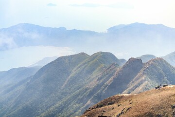 Fototapeta premium Scenic Mountain Ridge with Misty Background View, Lantau Peak, Hong Kong