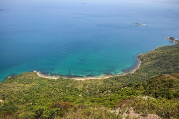 Scenic Coastal View of Lush Greenery and Clear Blue Waters