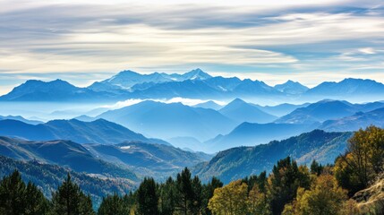 Obraz premium Serene mountain landscape with layered peaks and autumn foliage.