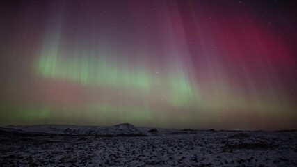 Vivid aurora borealis over snow covered volcanic terrain, Iceland - Powered by Adobe