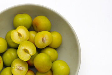 Fresh green plum fruit on white background.