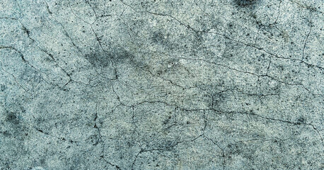 Close-up view of a cracked and weathered grey concrete surface. Classic retro texture for poster banner background and other digital needs.