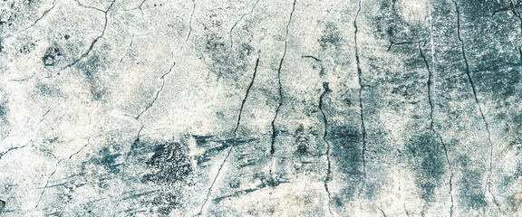 Close-up view of a cracked and weathered concrete surface, exhibiting a textured and distressed...