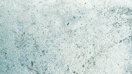Close-up view of a textured, light gray concrete surface with a weathered appearance. Classic retro texture for poster banner background and other digital needs.