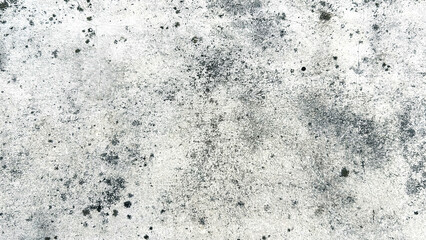 Close-up of a white wall with a crack and black stains, showcasing a distressed and textured surface. Classic retro texture for poster banner background and other digital needs.