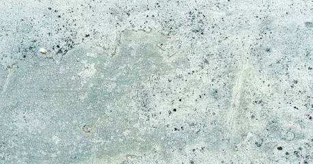 Close-up of a weathered, grey concrete wall with a rough texture and some cracks. Classic retro texture for poster banner background and other digital needs.