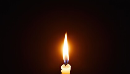 Fototapeta premium A candle is lit in the dark with a candle nearby 5