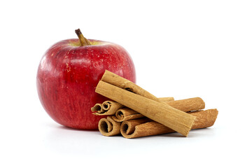 Fresh red apple with aromatic cinnamon sticks isolated on white background