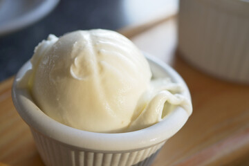 Indulge in a Delicious Scoop of Creamy Vanilla Ice Cream Served in a Chilled Cup