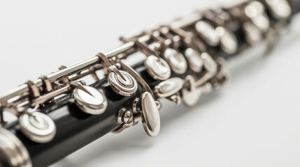 Fototapeta premium Close-up of a woodwind instrument focusing on silver keys, on white.