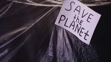 Save planet. Plastic pollution. Ecology problem. Banner with environmental slogan on wrinkled...