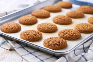 Close up of baking tray with low-calories oatmeal cookies.