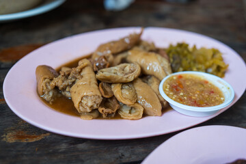 Stewed pork intestines served with seafood dip on pink dish