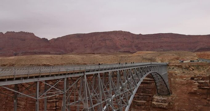Navajo Bridge Arizona Condors flying traffic endangered bird . Upstream from Grand Canyon. Wide steel arch spanning steep canyon walls . Home to endangered California Condor vulture. Largest bird USA.