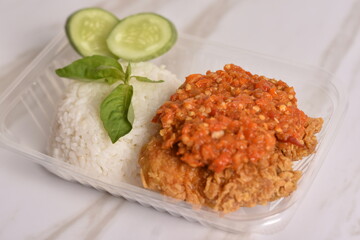 rice with chicken and sambal. It call ayam geprek in indonesia