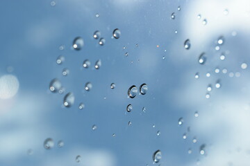 water drop on mirror with blue sky and white cloud background