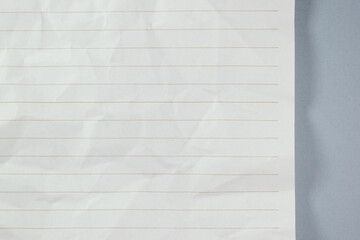 Naklejka premium crumpled line paper texture on grey background, blank sheet notebook