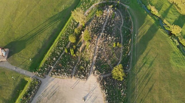 Aerial top-down view of Kryziu kalnas, or the Hill of Crosses, a site of pilgrimage near the city of Siauliai, in northern Lithuania. Sunny summer evening.