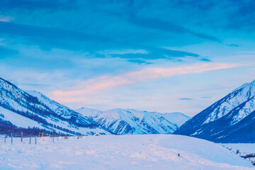 The villages and beautiful scenery of snow capped mountains and sunset in Hemu, Xinjiang