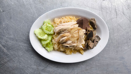 Chicken rice in a white plate on the dining table
