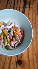 Chili and garlic in blue bowl on wooden table