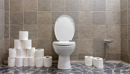 White porcelain toilet in a bathroom with multiple rolls of toilet tissue suggesting digestive problems including diarrhea
