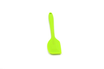 A Geen baking spatula on a white background