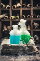 Vintage alchemist laboratory with manuscripts and chemical flask
