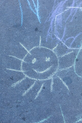 the sun is drawn with chalk on the asphalt. summer. banner place for text, children creativity