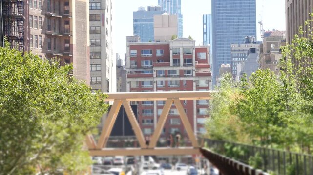 New York City High Line elevated greenway, Manhattan Midtown, USA. People in urban park. Promenade in garden greenery. American street life, Chelsea highline near Hudson Yards. Building architecture.