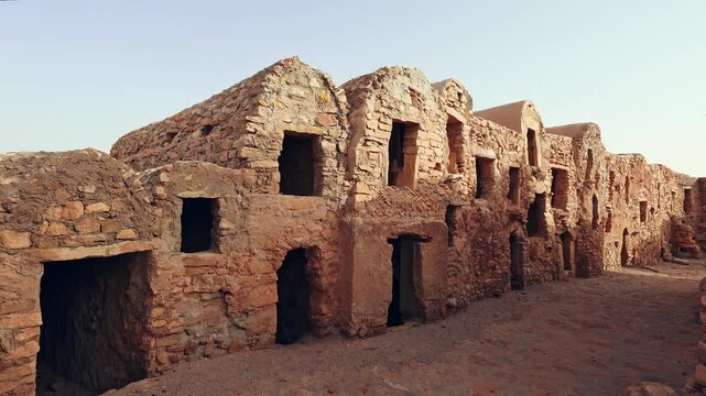 Ruins of ancient abandoned Berber granary structures in Ksar Daghar in Tunisia, standing as testament to traditional North African architecture